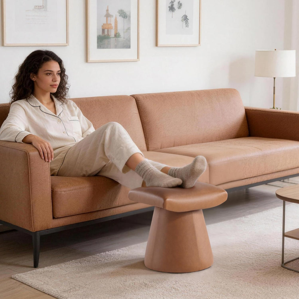 Archer Pro Saddle Ottoman in saddle tan faux leather with a unique curved U-shaped design.